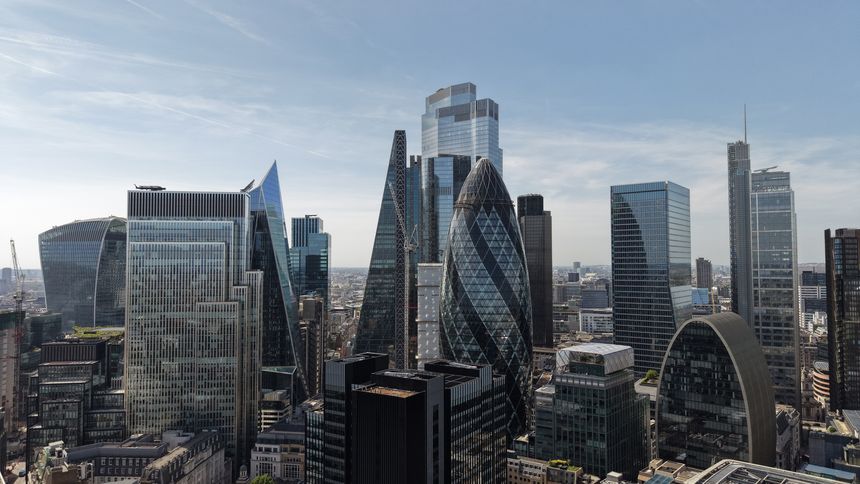 An aerial perspective of the London financial district showcases a cluster of modern skyscrapers.