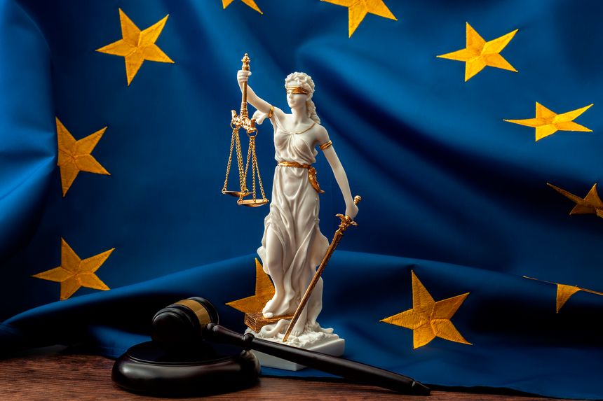 European union court of justice or ECJ, legal system in Europe and the legislature branch of government concept with a gavel, a statue of Themis the lady of justice and the EU flag