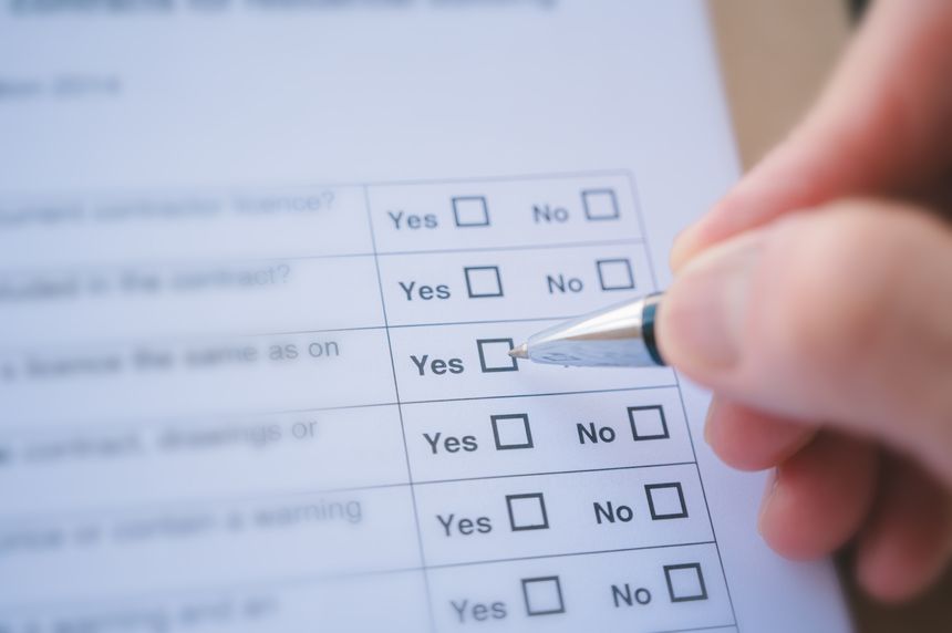 close up and selective focus hand using pen to making tick mark on check list box check list and marker