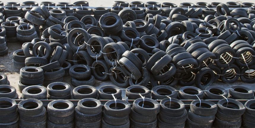 large heaps of old worn out used vehicles tires