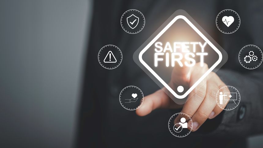 Work safety concept. Businessman touching Safety first text . Safety first sign on virtual screen. Hazards, protections, regulations and insurance, Zero accidents, Protection dangerous.