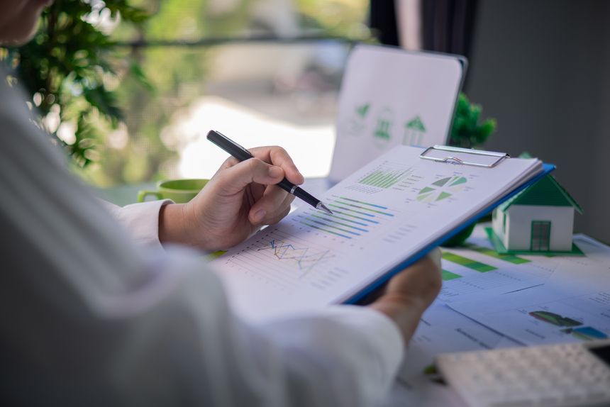 Analyzing green building performance metrics during business meeting. data analysis, green building, business meeting, sustainability, performance metrics, charts, graphs, real estate, eco-friendly.