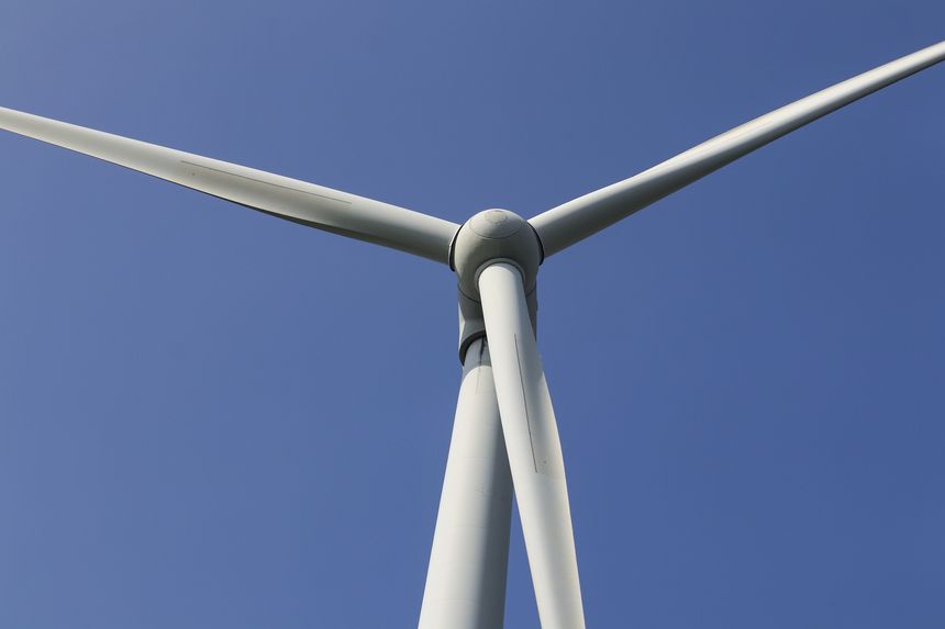Spinning wind turbine at the rural areas of india. a powerful wind farm for energy production under a sky. Wind mills factory on the hill of gujarat.