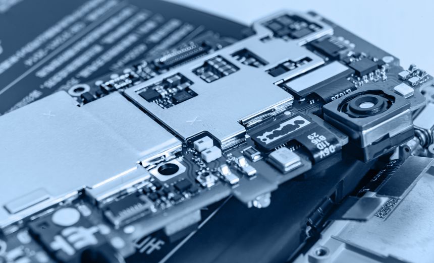 Macro view of a smartphone motherboard and camera module showcasing tiny electronic components, connectors, and circuitry, conveying technology, repair, engineering, and precision electronics manufacturing.