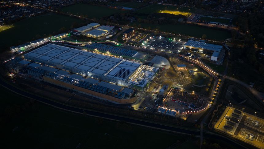 Data center under construction at Waltham Cross, England. computer systems and associated components, such as telecommunications and storage systems. Artificial intelligience and Cloud services. Expanasion of IT technology. Aerial drone video at night.