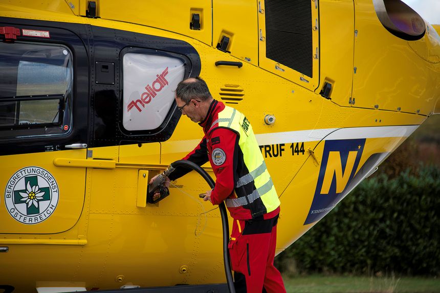 Krems, Austria - 10 25 2025: Helicopter of the Air rescue team in Austria named Christophorus refueled by a crew member