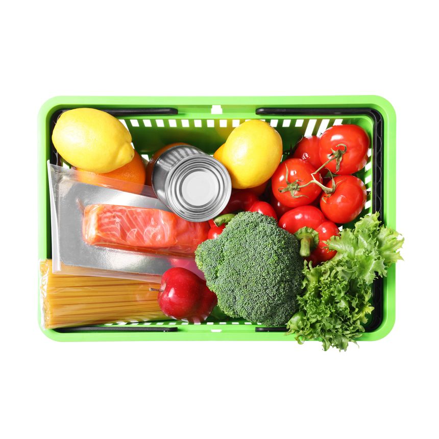 Plastic shopping basket full of products isolated on white, top view