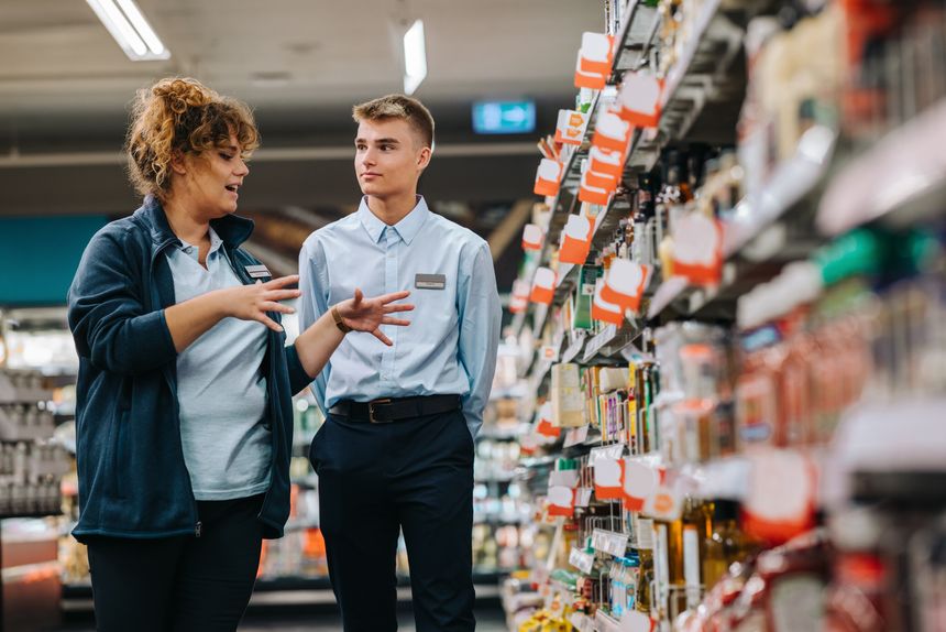 Store incharge training young worker. Supermarket manager giving training to a trainee.