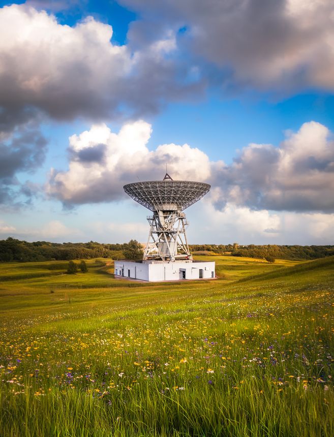 A large Satellite dish or antenna pointing directly upwards and sending and receiving signals and messages from deep space