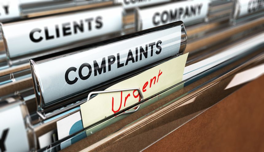 Close up on a file tab with the word complaints, focus on the main text and blur effect. Concept image for illustration of Customer Service complaint management