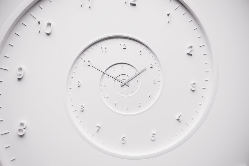 Abstract white spiral clock with repeating dials and 3D numbers, creating a surreal visual illusion of infinite time. Concept of time travel, eternity, or philosophical time loop.
