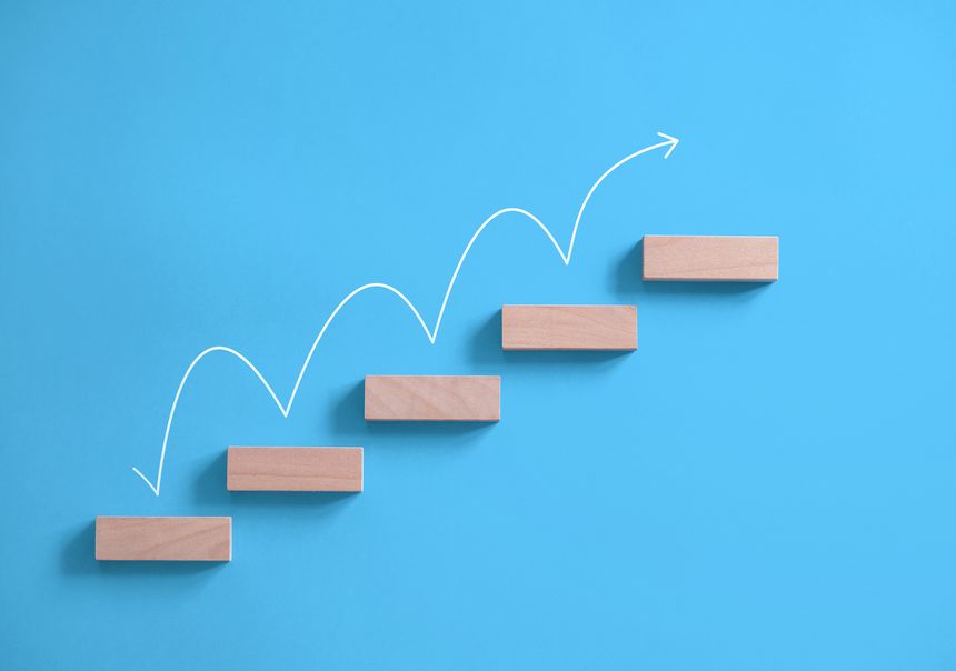 Wooden blocks with white arrow, stairs to the success concept with copy space