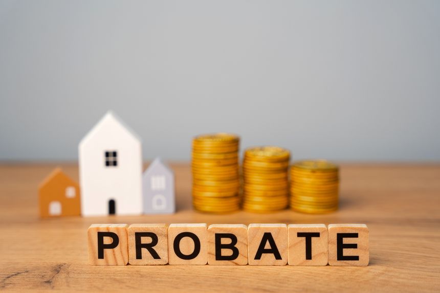 Real estate that is part of a deceased person's estate and managed or distributed through the probate process. Wooden blocks Probate and miniature houses.