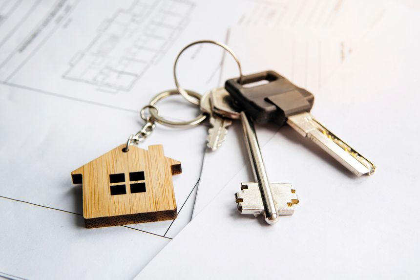 keychain in the form of a house. Model house, construction plan for house building, keys. Real Estate Concept. Top view.