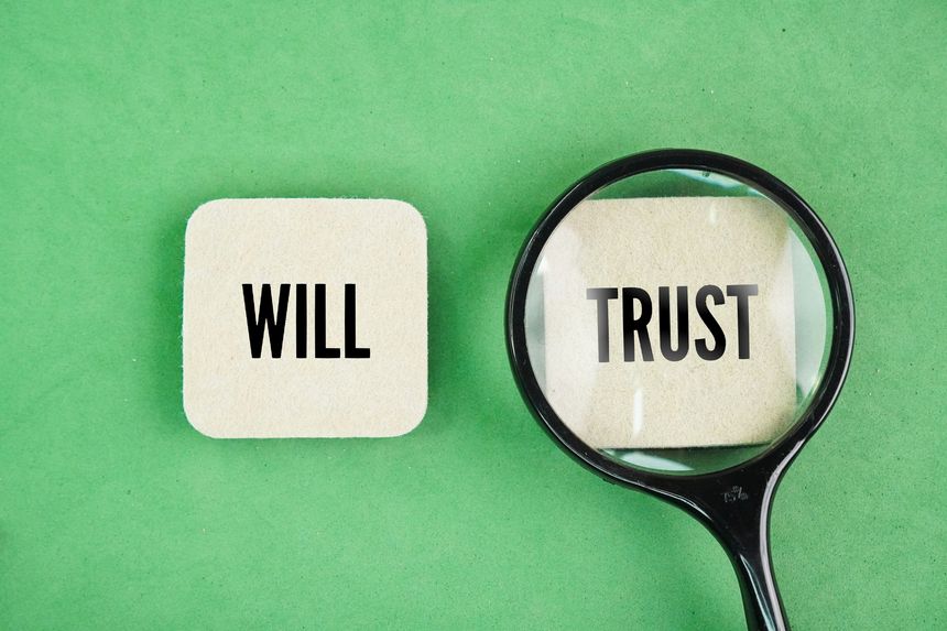 A magnifying glass with the words trust vs will. living trust might be more than you need for your situation, but it can be a great tool if you have a larger or more complex estate