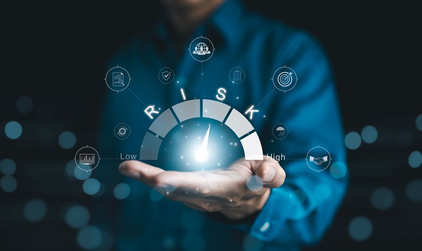 Risk Management and Assessment Concept. A person holding digital risk gauge in their hand, with icons represents various aspects of risk management and assessment, indicating different levels of risk.