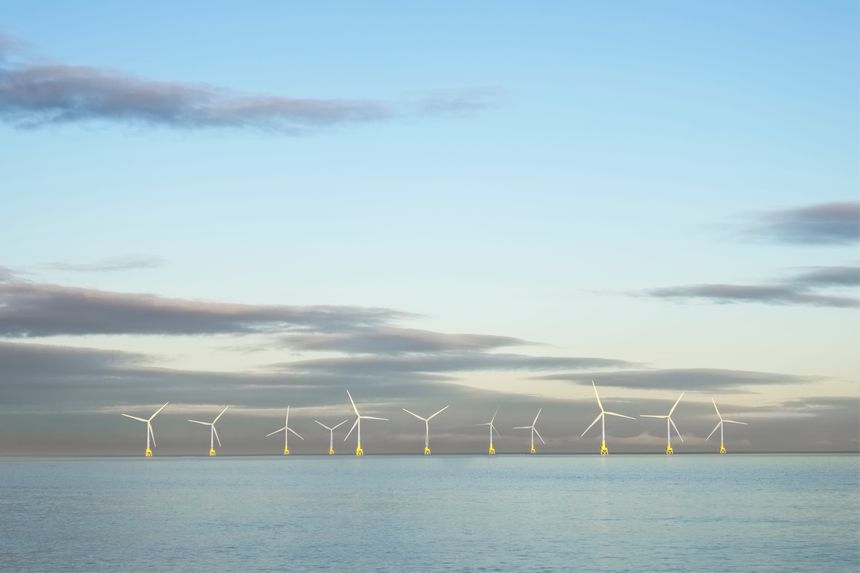 Wind farm in north sea ocean floating turbines on horizon offshore at Aberdeen to generate energy and electricity uk