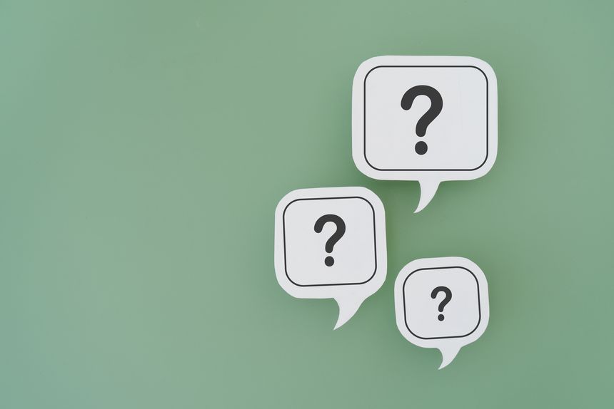 For FAQ , Frequently asked questions concept, asked questions  and answers. Question mark on  different size of white speech bubble real paper cut on green background, copy space included