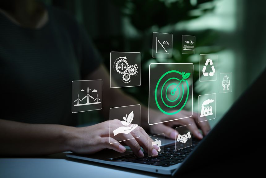 Green Energy and Sustainability Concept. Person using laptop with icons of sustainability, renewable energy, recycling, environmental goals, eco-friendly technology, and sustainable business practice.