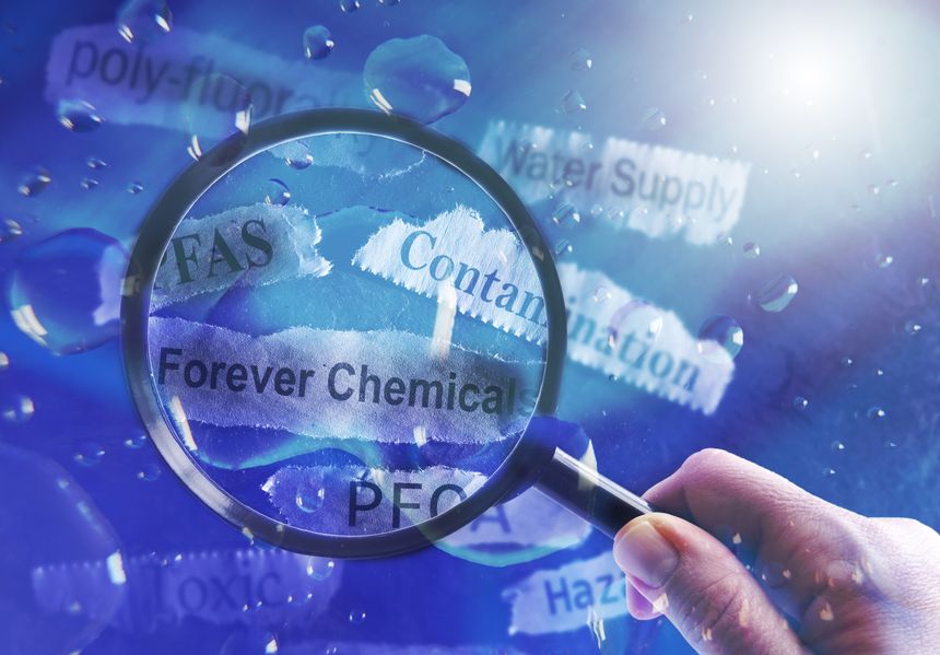 PFAS Forever Chemicals water and newspaper headlines with magnifying glass