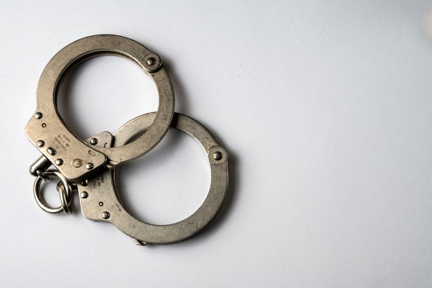 Metal handcuffs and white background