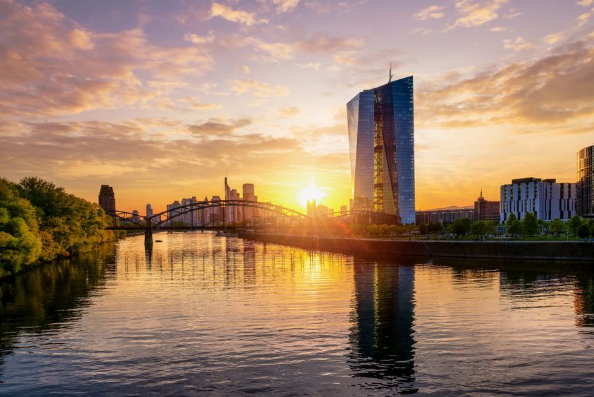 The skyline of Frankfurt am Main, Germany, during a colorful summer sunset with modern finance buildings and reflections in the Main river