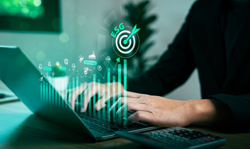 Businessman using laptop with ESG concept icons and growing bar chart, focusing on sustainability strategy, environmental responsibility, social impact and corporate governance performance metrics