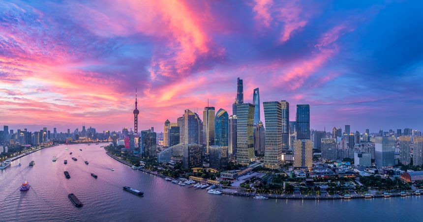 Shanghai downtown business buildings skyline and river at dusk