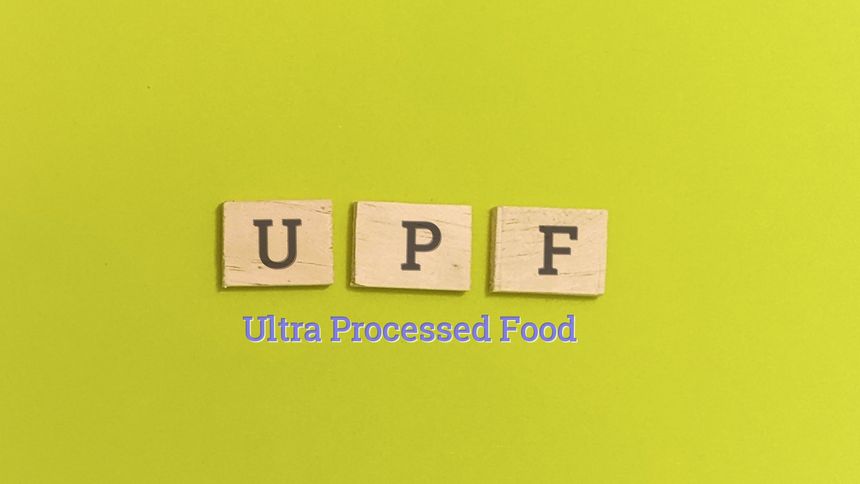 Ultra Processed Food concept with wooden blocks on green background