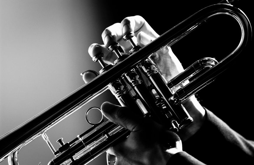 A shot close up hand play trumpet in black and white photo