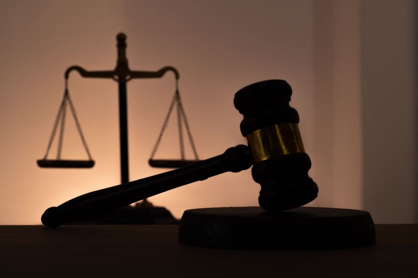 Silhouettes of a judge's gavel and scales of justice. Symbol of law, rights, legal protection, and the court. Law firm logo idea