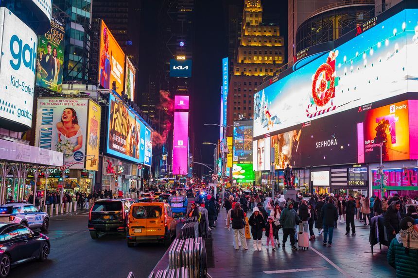New York City, NY, USA - Dec 10, 2025: Tourist explore the famous Times Square in the heart of Manhattan at night.