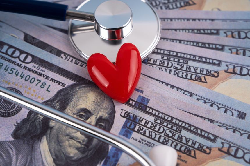 Stethoscope with heart shape and financial bill medical and healthcare concept