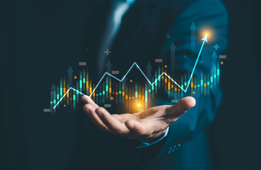 Hand holding holographic financial stock market graph with rising arrows. Concept of investment, economic growth, profit success, and trading analysis.