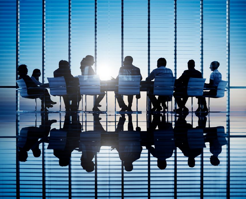 Silhouettes of business people in a conference room.