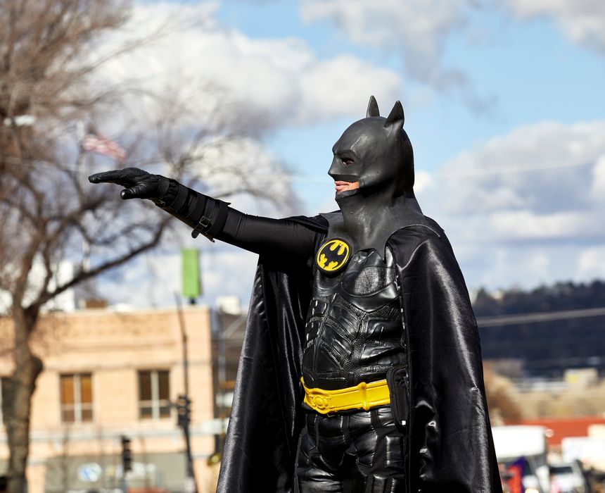 Prescott, Arizona, USA - December 1, 2018: Man wearing a batman costume waving while marching in the Christmas parade in downtown Prescott