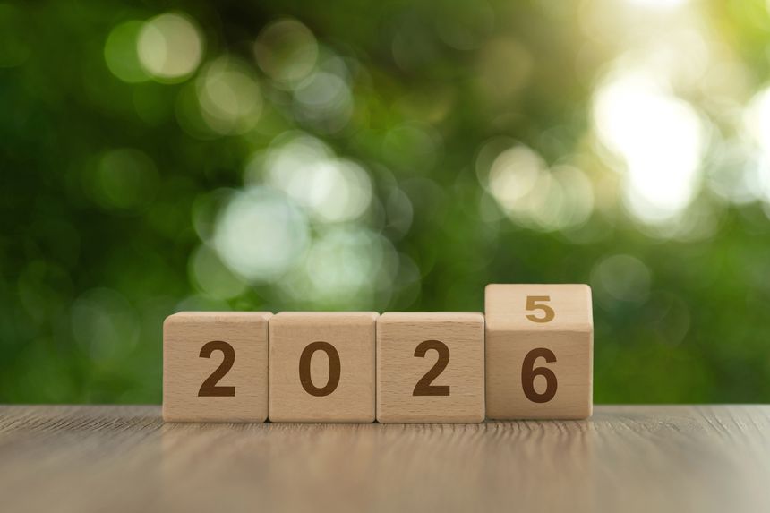 Wooden cube blocks flipping from 2025 to 2026 on green bokeh background, symbolizing New Year goals, resolutions, planning, countdown, fresh start, business campaigns and greetings. copy space