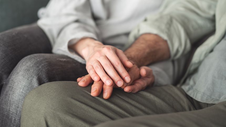 Comforting hand supporting the old man