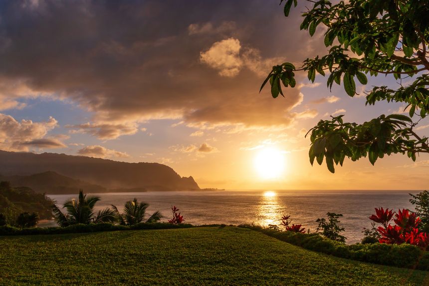 Scenic view of North Shore of Hawaiian island of Kauai with its famous Napali coast at sunset against blue sky with clouds