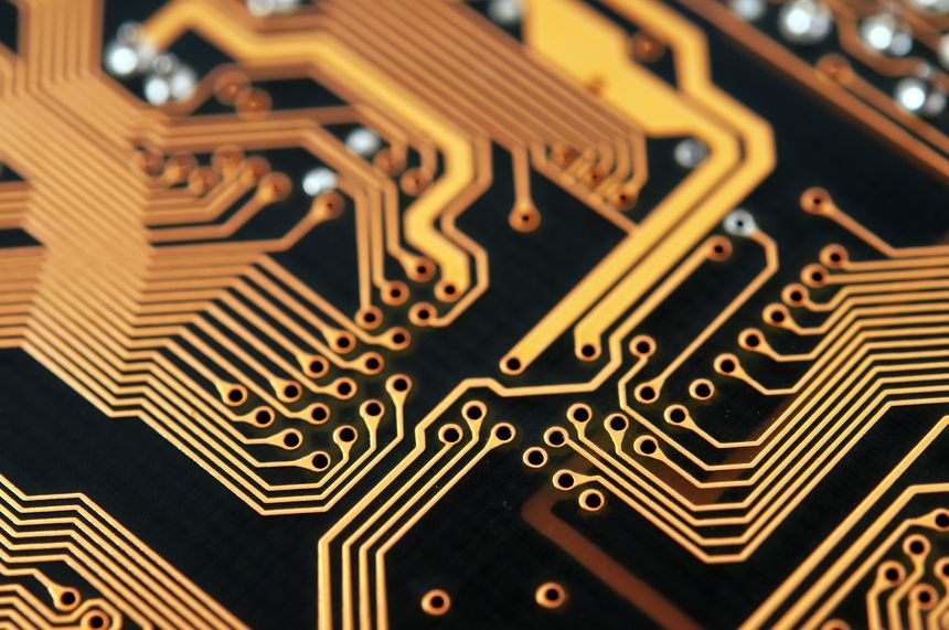 Close-up photo of circuit board in gold and black.