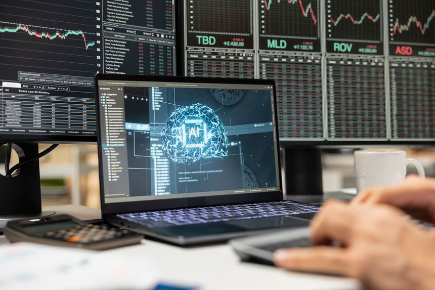 Close up of day trader using AI tech on laptop capitalize on market fluctuations when buying and selling stocks. Prop firm office worker uses artificial intelligence to identify profit opportunities