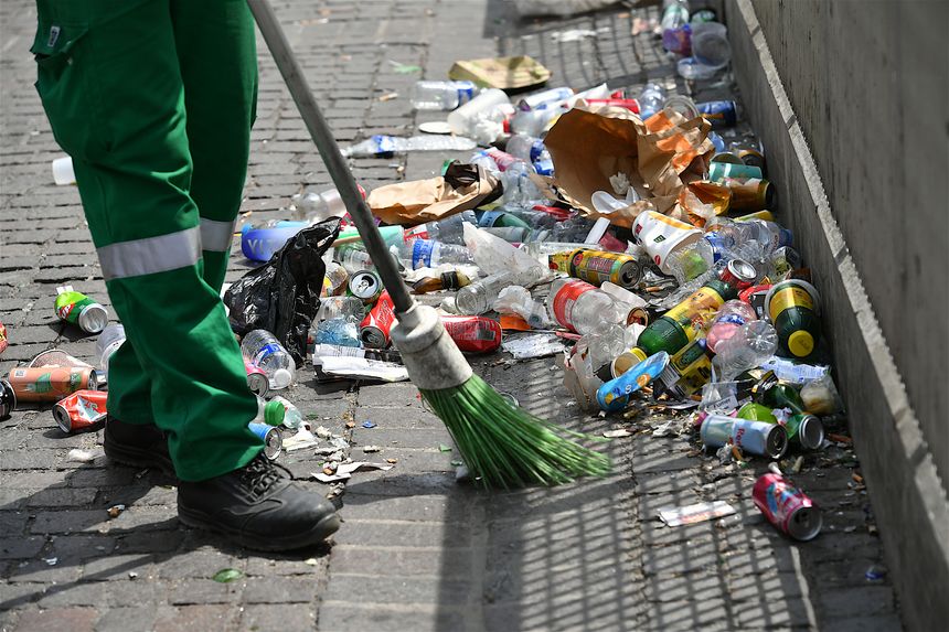 Paris, France-June 22 2025: A municipal sweeper cleans the rubbish cluttering a Parisian street, France.