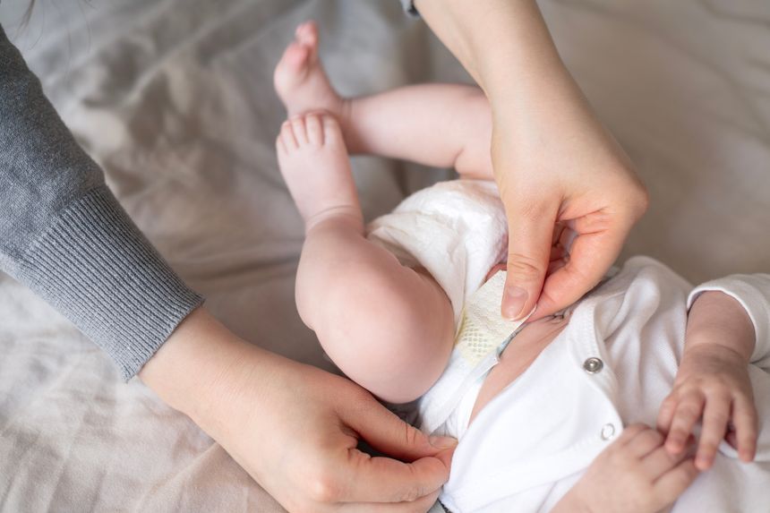 Cropped shot of a woman changing a baby's diaper