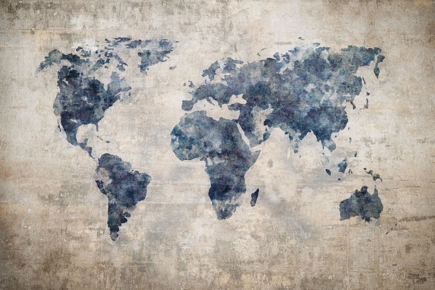 Grunge world map on vintage paper background in watercolour style.