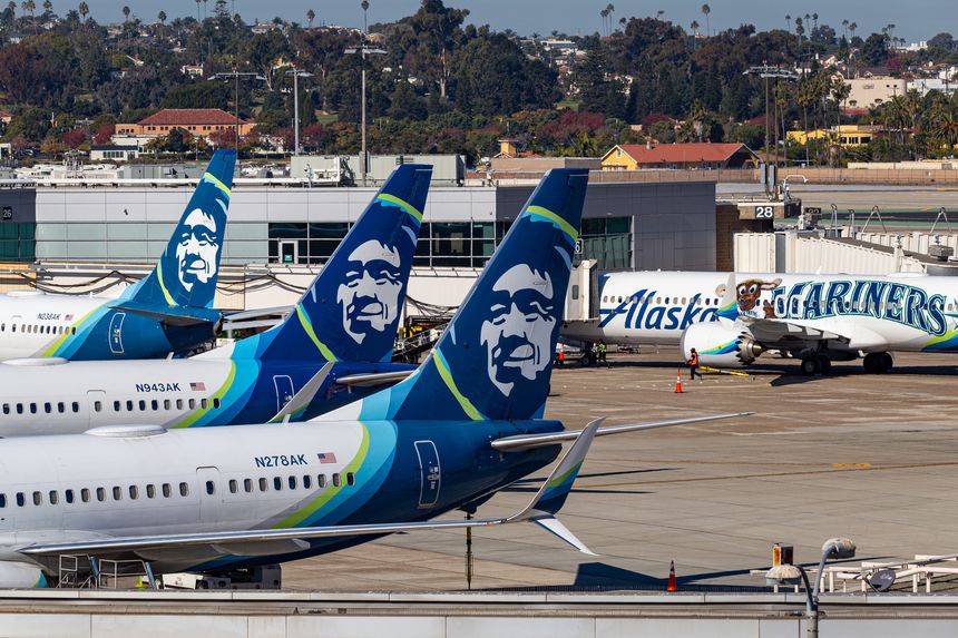 San Diego, CA - December 1, 2024: Photo of several Alaska Airlines passenger planes at San Diego International Airport (SAN) Terminal 2, including one painted in 'Seattle Mariners' color