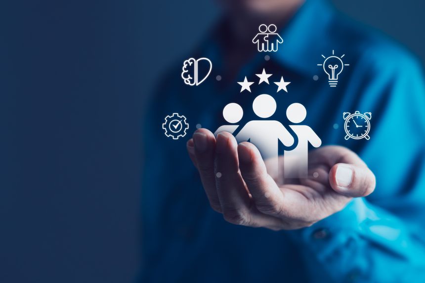 Businessman holding digital icons of a team with stars above, surrounded by productivity, innovation, collaboration symbols, human resource management, customer satisfaction, employee performance