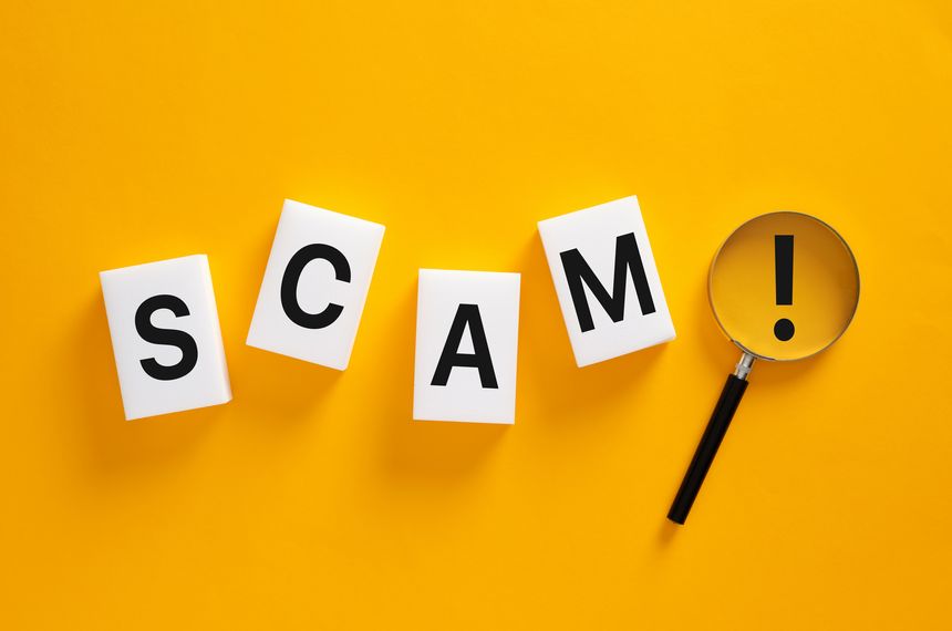 Scam word tiles with a magnifying glass showing an exclamation mark, indicating caution, fraud alert, and investigation