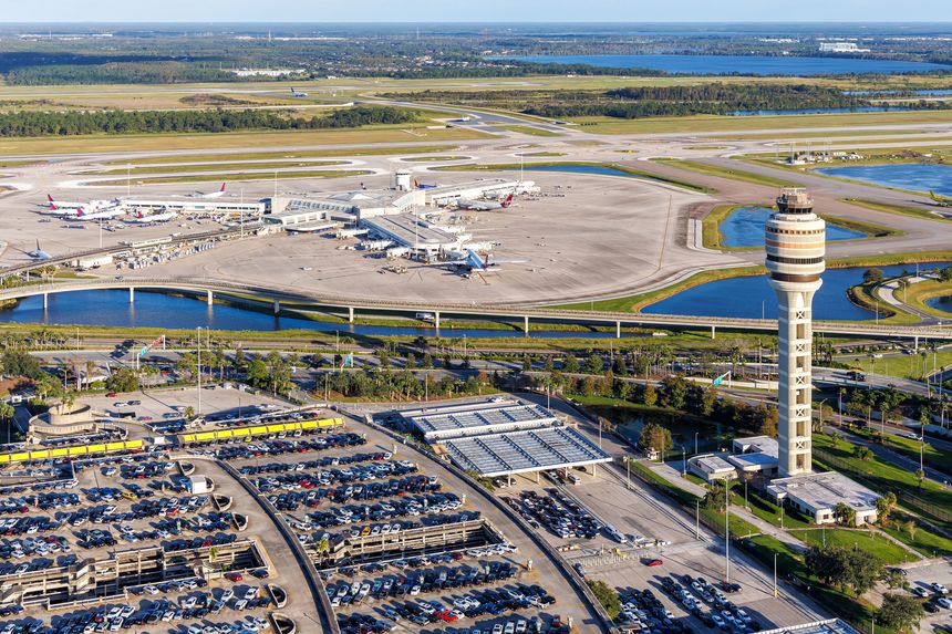 Orlando, United States - October 17, 2024: Aerial view photo of Orlando International Airport with Terminal Concourse Airside 4 and Tower in Orlando, United States.