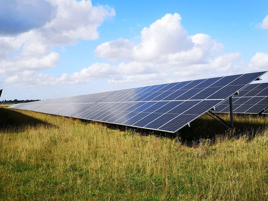 Solar Panels in countryside with blue sky and clouds