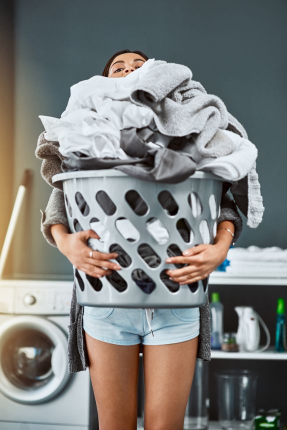 Shot of an unrecognizable woman doing her laundry at home